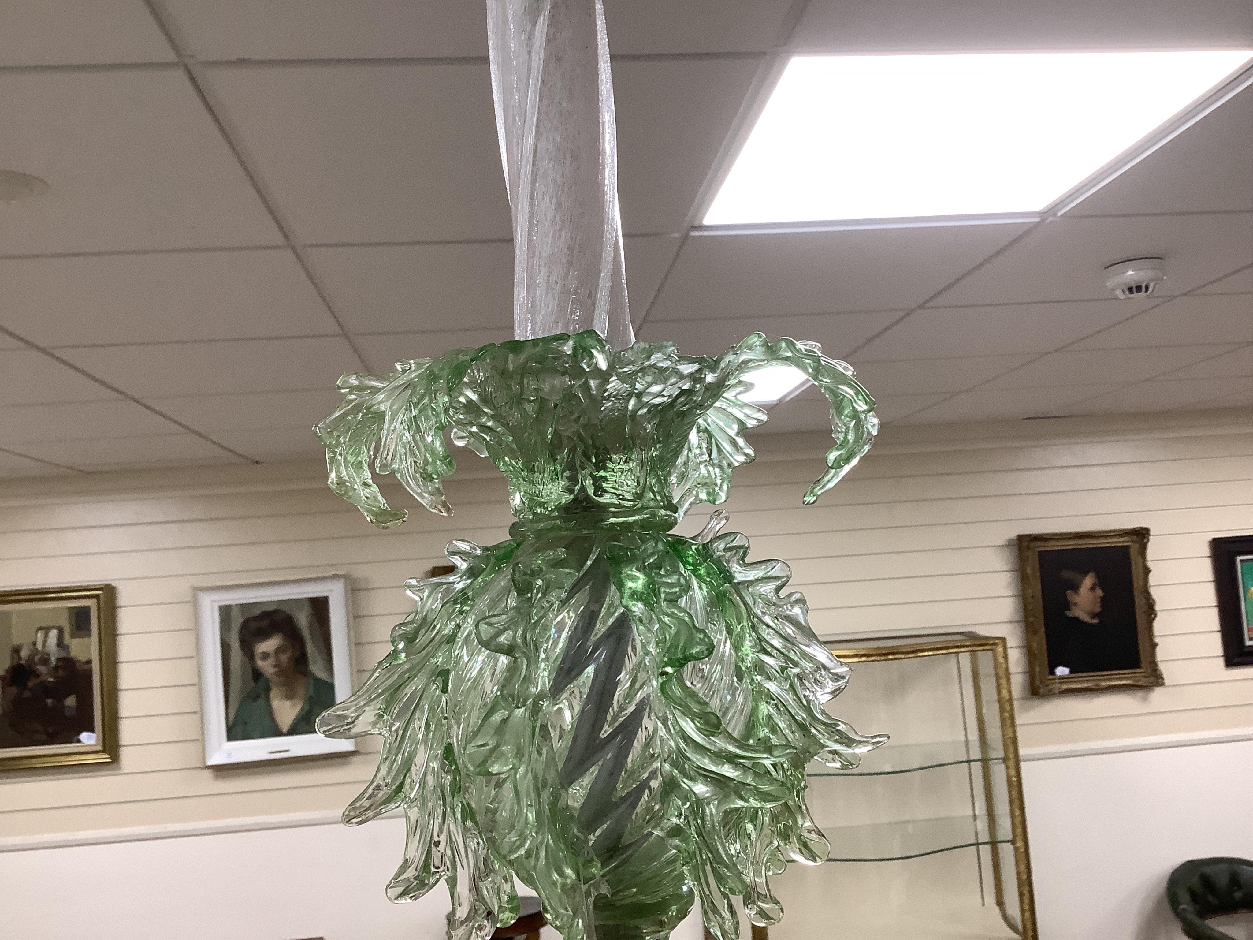 An ornate leaf and floral green glass Murano three branch chandelier, 84cm high.